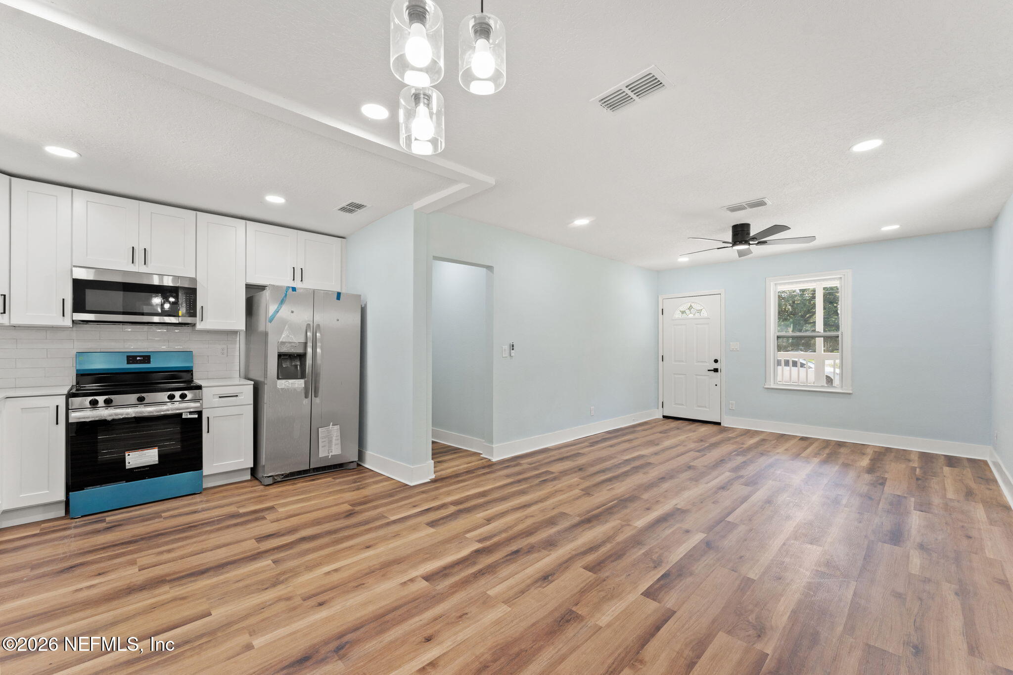 2655 Community Road Jacksonville, FL 32207 - Photo 12 of 26 a view of a kitchen with a sink refrigerator and wooden floor