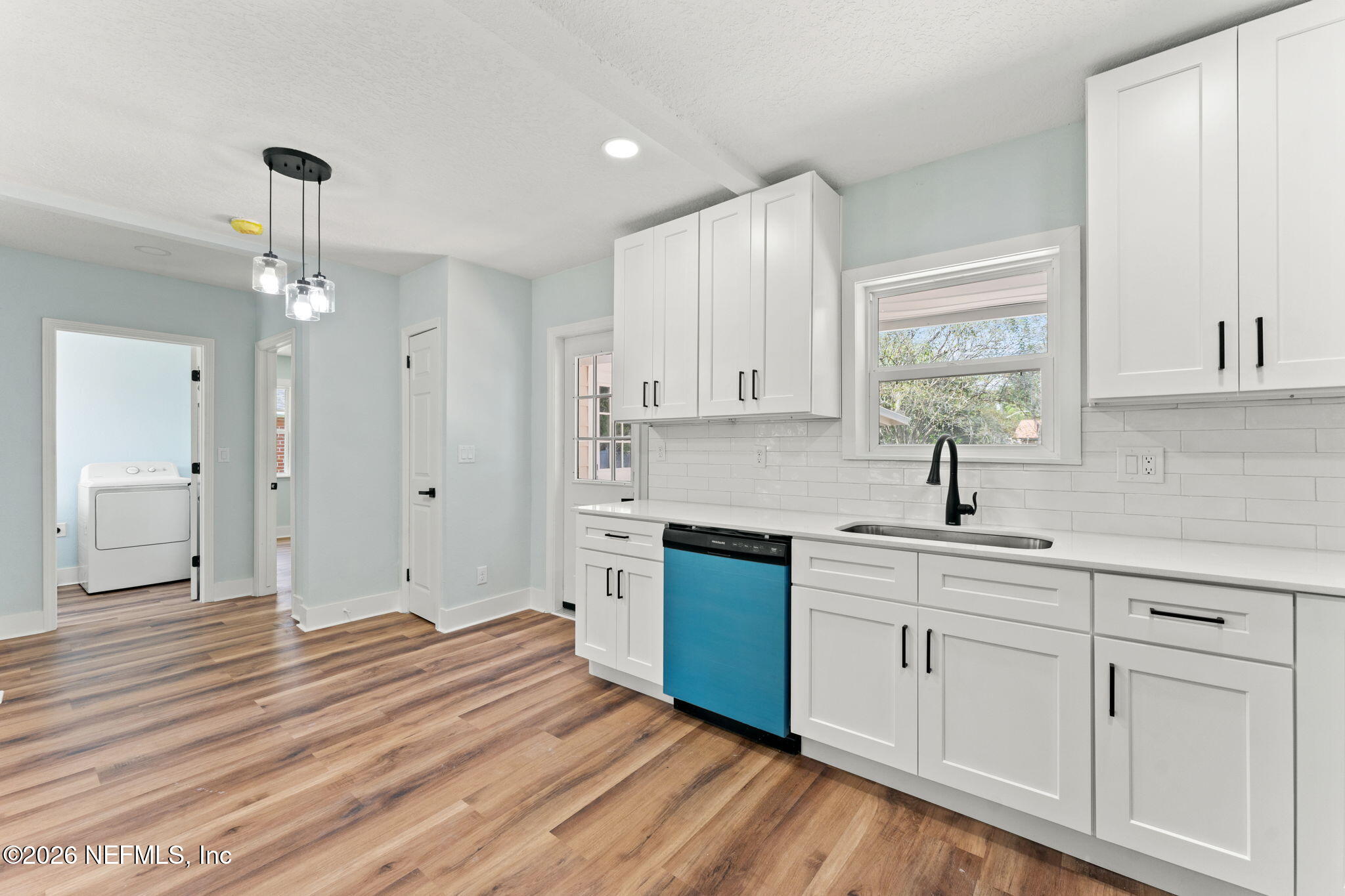 2655 Community Road Jacksonville, FL 32207 - Photo 13 of 26 a kitchen with white cabinets and sink
