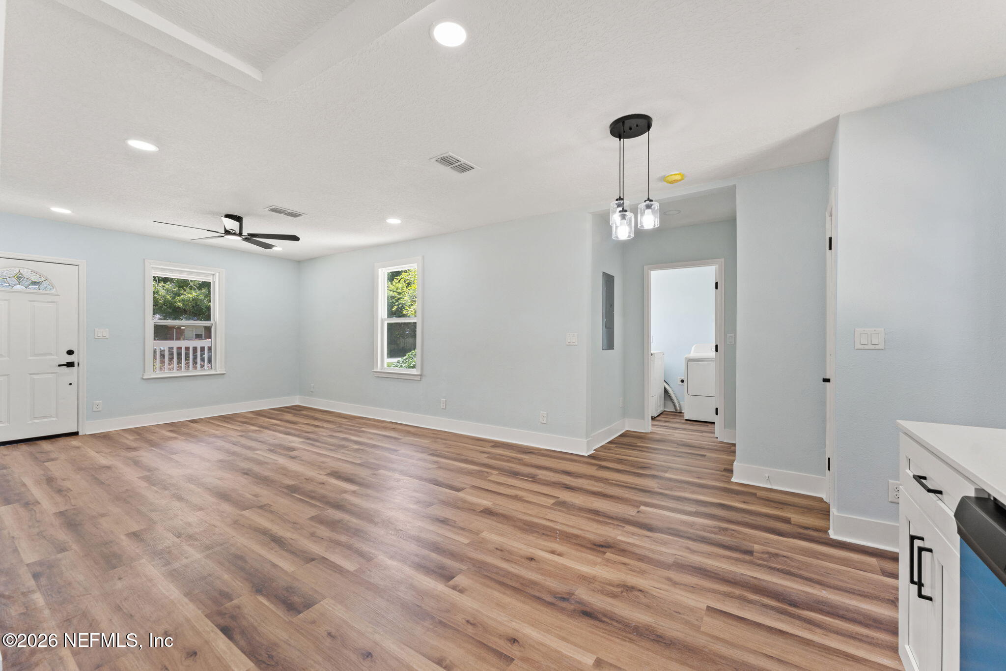 2655 Community Road Jacksonville, FL 32207 - Photo 14 of 26 a view of a livingroom with wooden floor and a ceiling fan