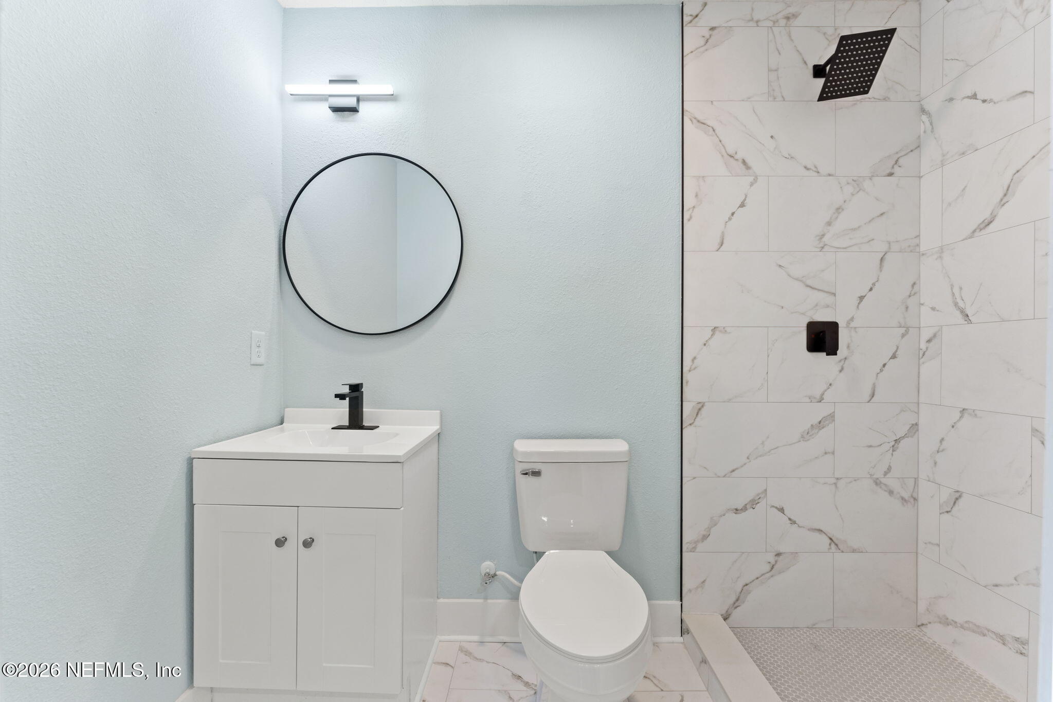 2655 Community Road Jacksonville, FL 32207 - Photo 18 of 26 a bathroom with a toilet sink and mirror