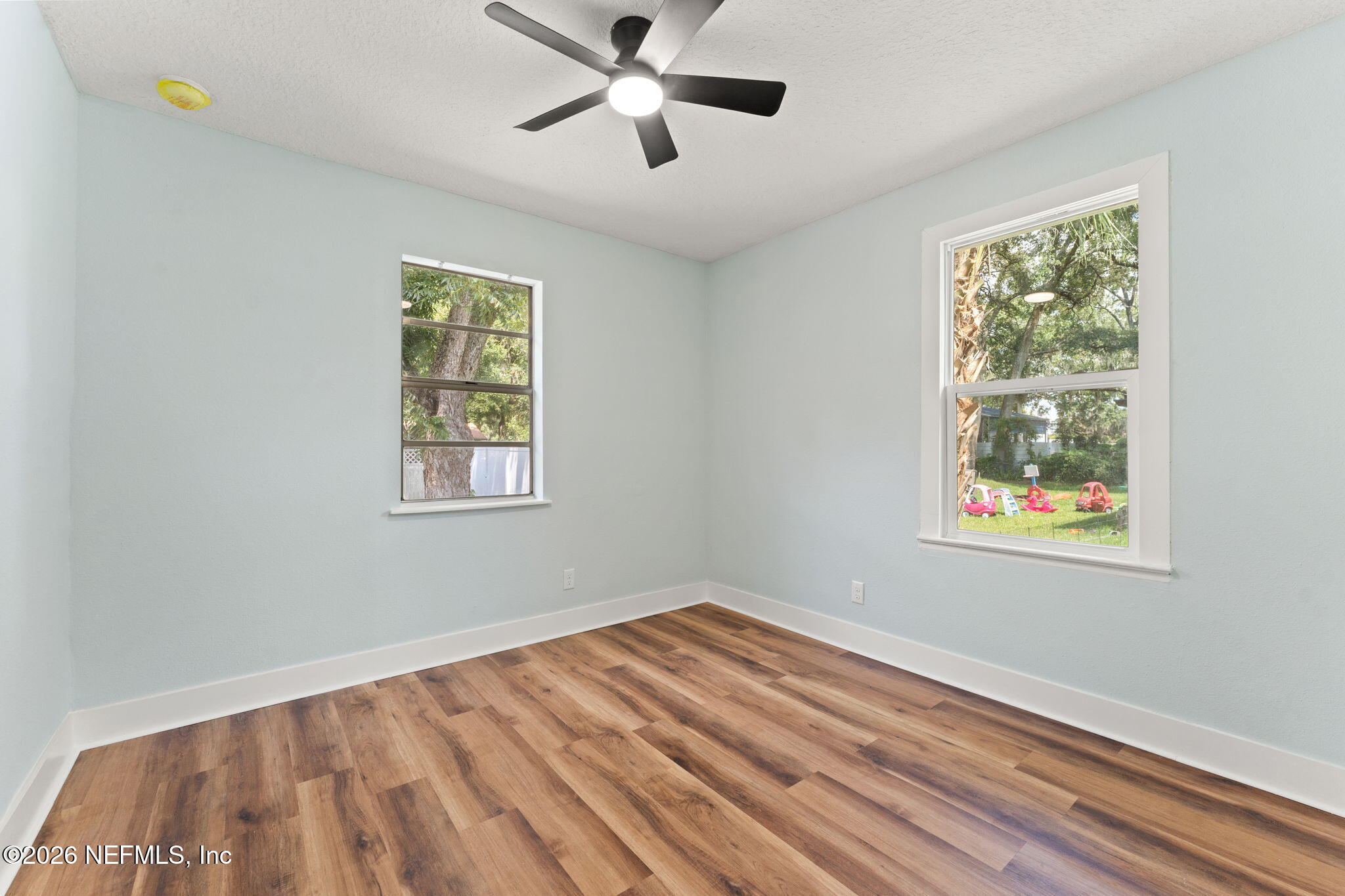 2655 Community Road Jacksonville, FL 32207 - Photo 21 of 26 a view of empty room with wooden floor and fan