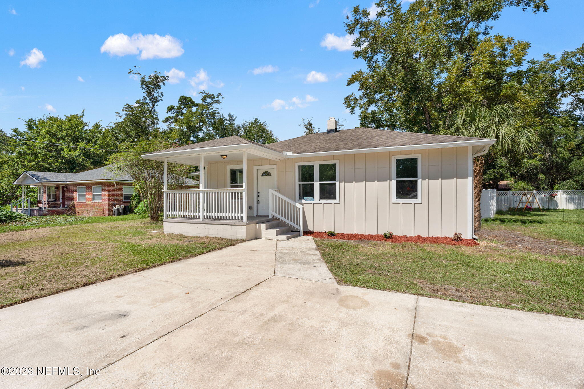 2655 Community Road Jacksonville, FL 32207 - Photo 4 of 26 a front view of a house with a garden and trees