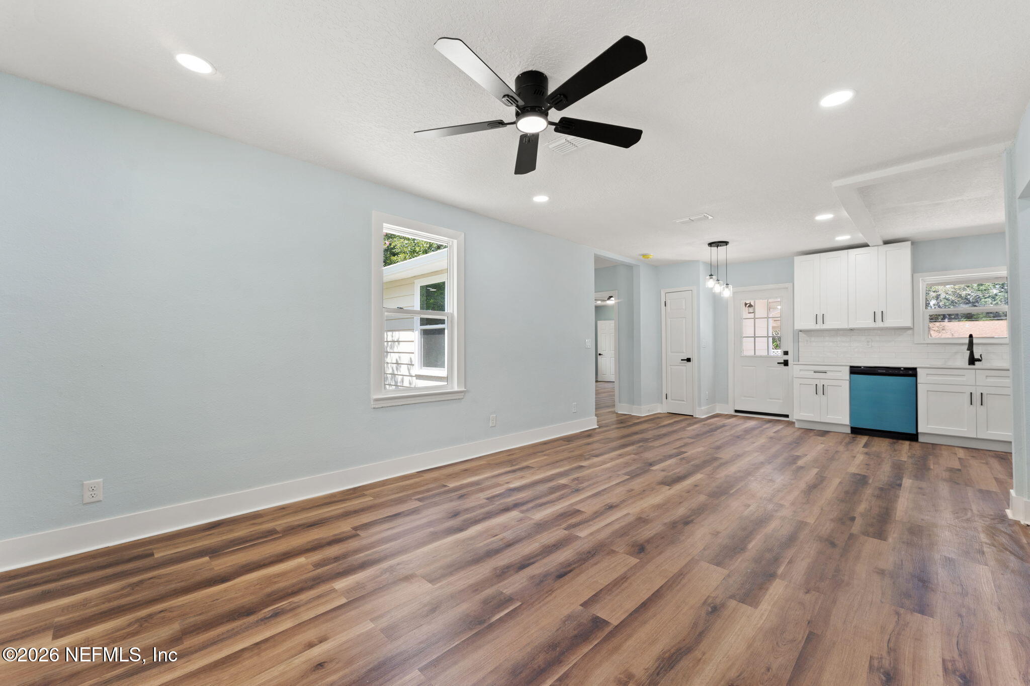 2655 Community Road Jacksonville, FL 32207 - Photo 8 of 26 a view of a livingroom with a ceiling fan a ceiling fan and kitchen view