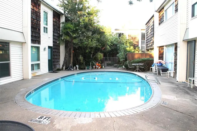 a view of swimming pool with outdoor seating