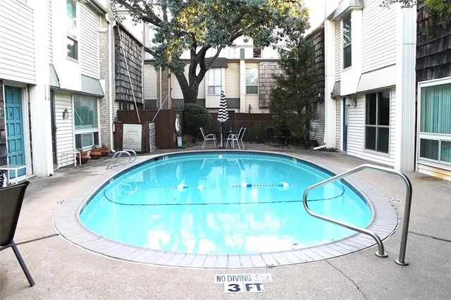 a view of a swimming pool with an outdoor seating