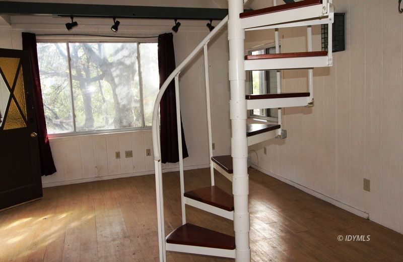 24601 Bluff Road Idyllwild, CA 92549 - Photo 12 of 24 a view of an empty room with a window and wooden floor