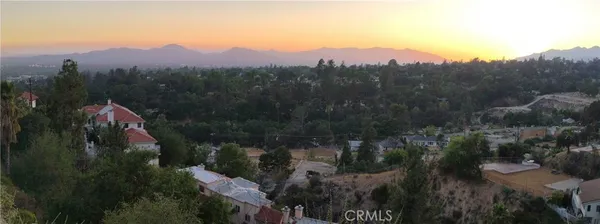 a view of a town with mountains in the background