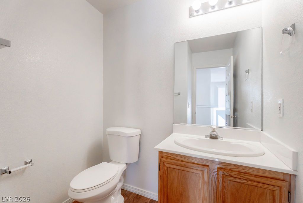 8379 Rockefeller Street Las Vegas, NV 89123 - Photo 17 of 36 A classic wood vanity and solid surface countertop anchor this clean half bath.