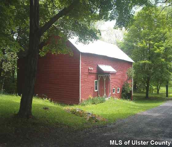 101 Oakley Stone Ridge, NY 12484 - Photo 2 of 4 a view of a brick house with a large windows and large trees