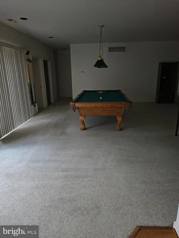 a room with pool table and a projector