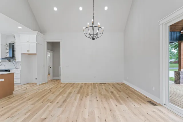 a view of a room with wooden floor and window