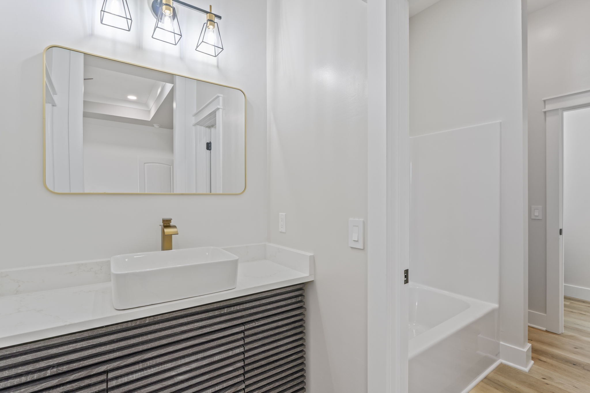 1601 Old Estill Springs Road Tullahoma, TN 37388 - Photo 12 of 37 a bathroom with a sink a mirror and bathtub