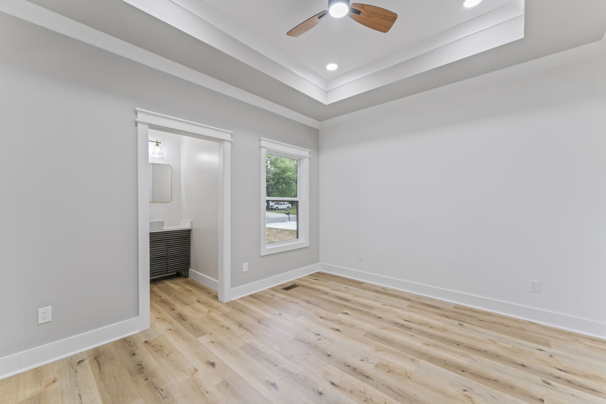 1601 Old Estill Springs Road Tullahoma, TN 37388 - Photo 16 of 37 an empty room with wooden floor and windows