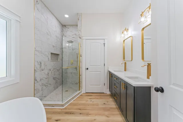 a bathroom with a granite countertop sink a toilet and shower