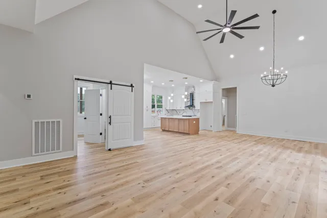a view of a room with wooden floor and a ceiling fan
