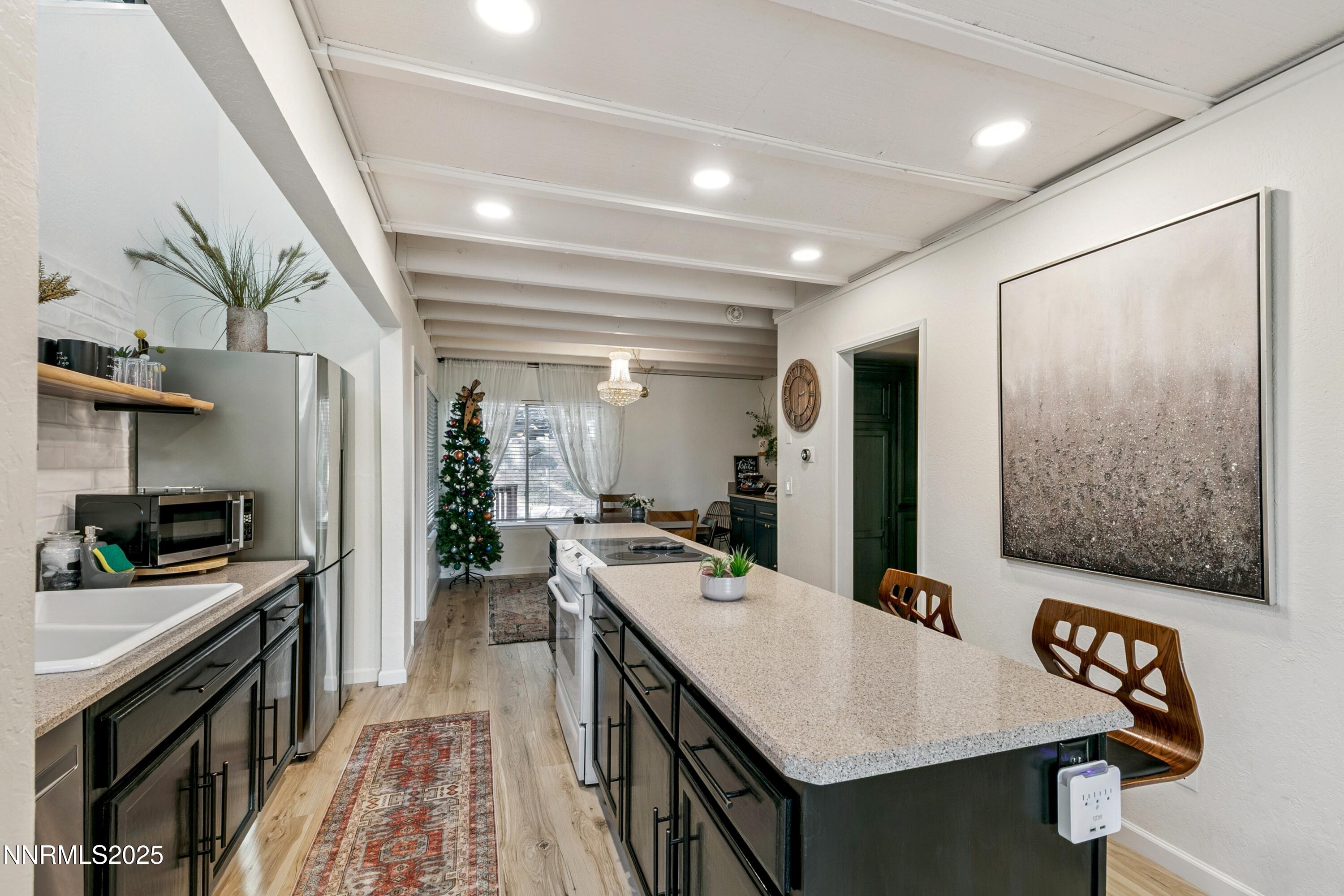 230 Clubhouse Circle Stateline, NV 89449 - Photo 11 of 44 a kitchen with a sink stainless steel appliances and cabinets