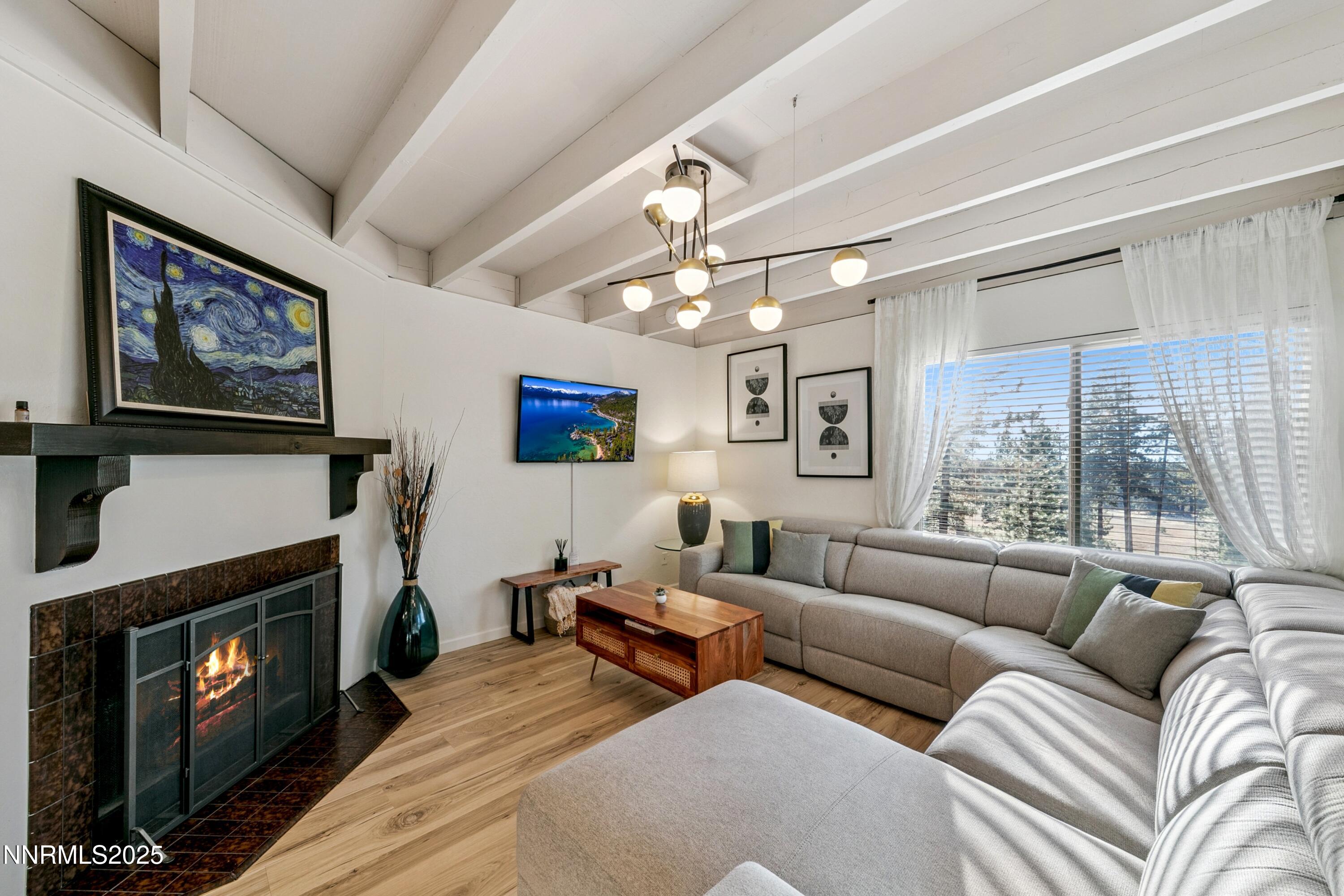230 Clubhouse Circle Stateline, NV 89449 - Photo 12 of 44 a living room with furniture a flat screen tv and a fireplace