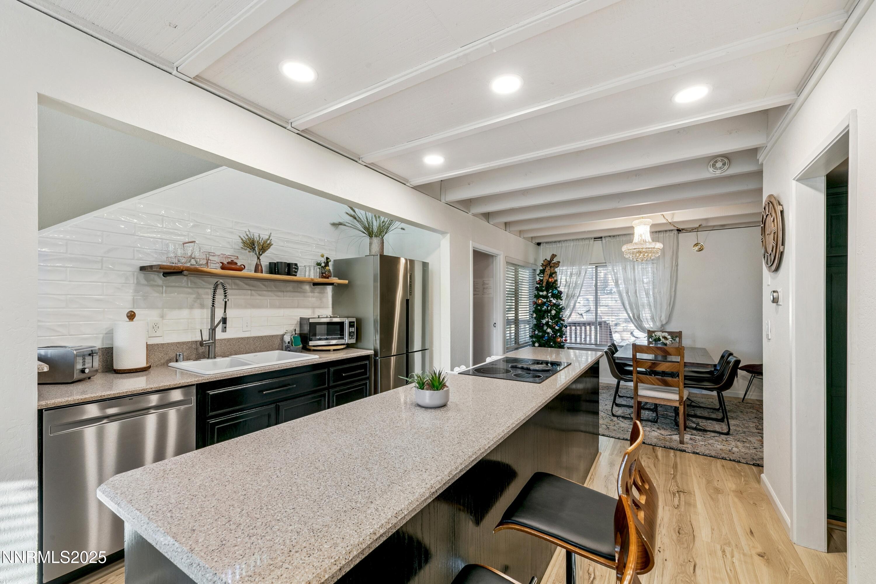 230 Clubhouse Circle Stateline, NV 89449 - Photo 13 of 44 a large kitchen with a table and chairs
