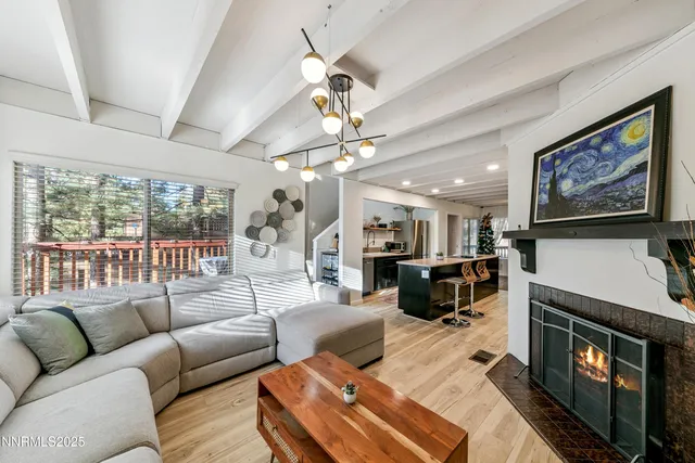 a living room with furniture a large window and a flat screen tv