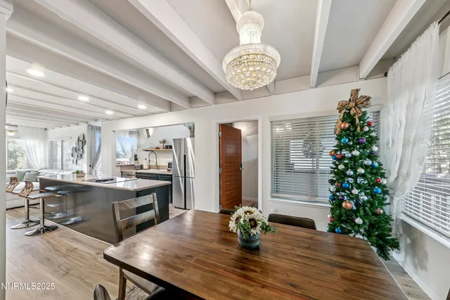 a large kitchen with a table and chairs