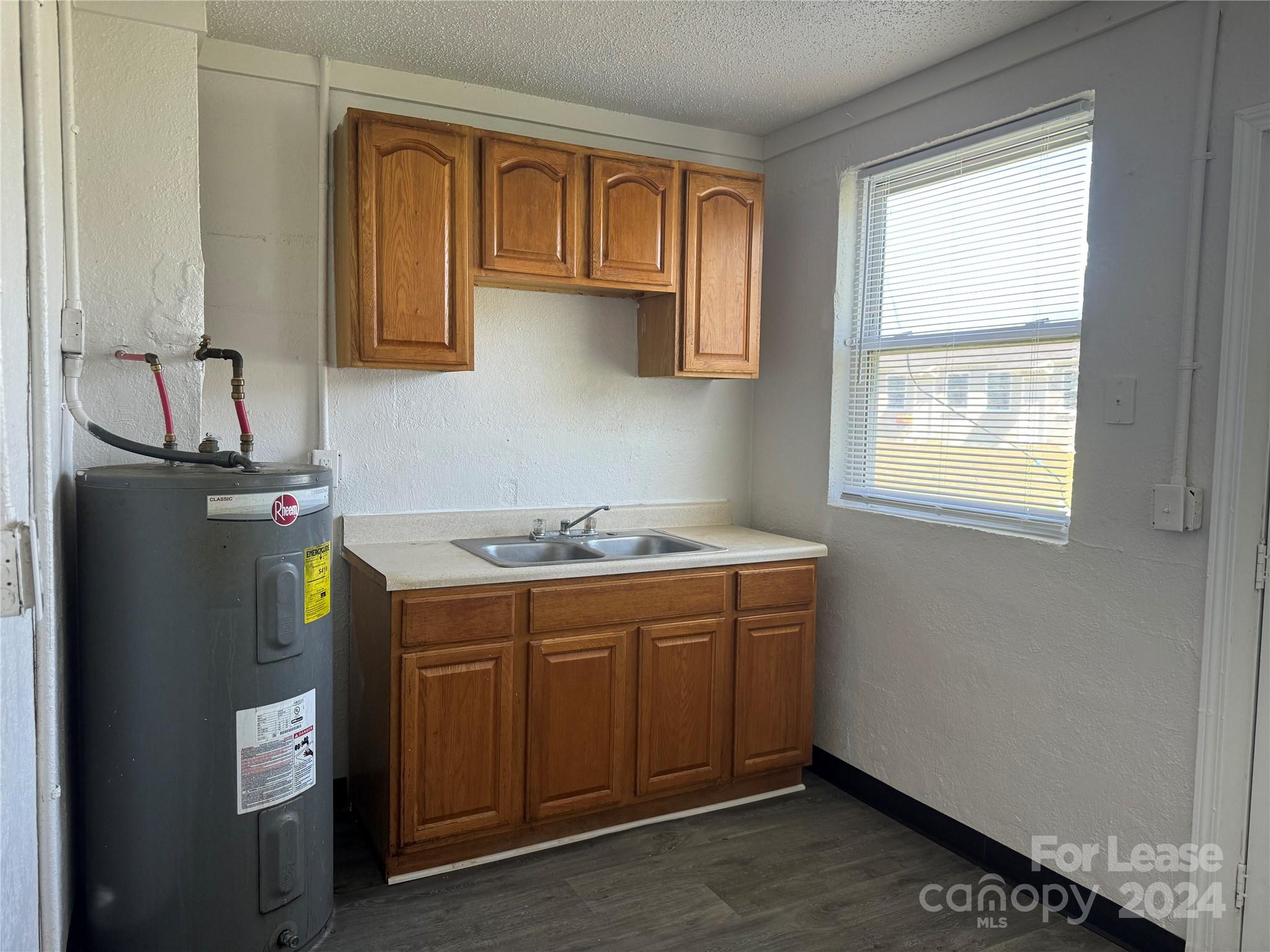 a utility room with cabinets washer and dryer