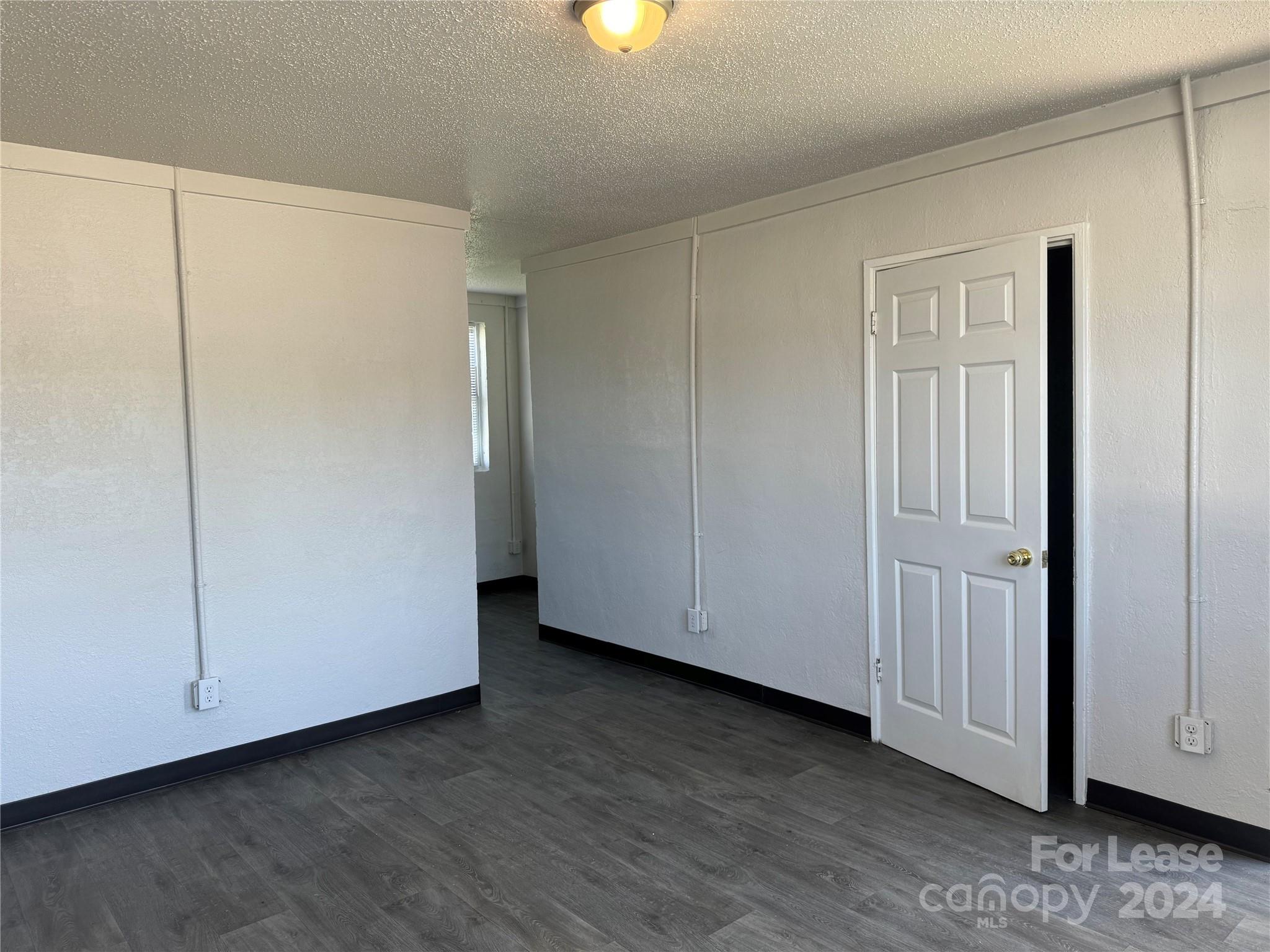 200 York Street, Unit M6 Chester, SC 29706 - Photo 4 of 14 a view of an empty room with wooden floor