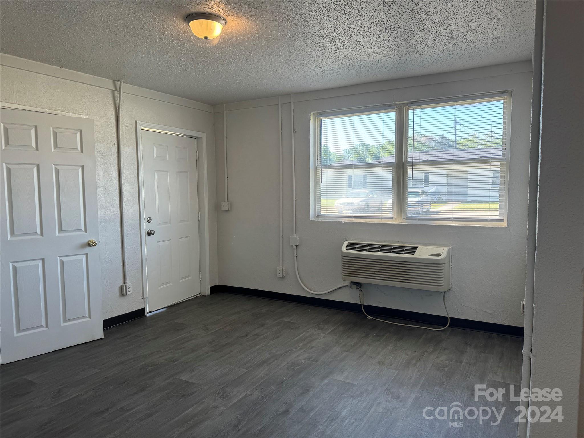 200 York Street, Unit M6 Chester, SC 29706 - Photo 5 of 14 an empty room with wooden floor and windows