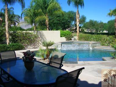 303 Loch Lomond Road Rancho Mirage, CA 92270 - Photo 22 of 25 a view of a swimming pool with a patio and a garden