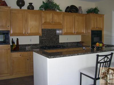 303 Loch Lomond Road Rancho Mirage, CA 92270 - Photo 10 of 25 a kitchen with a sink a microwave and cabinets