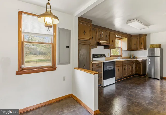 a kitchen with stainless steel appliances granite countertop a refrigerator a stove and a sink