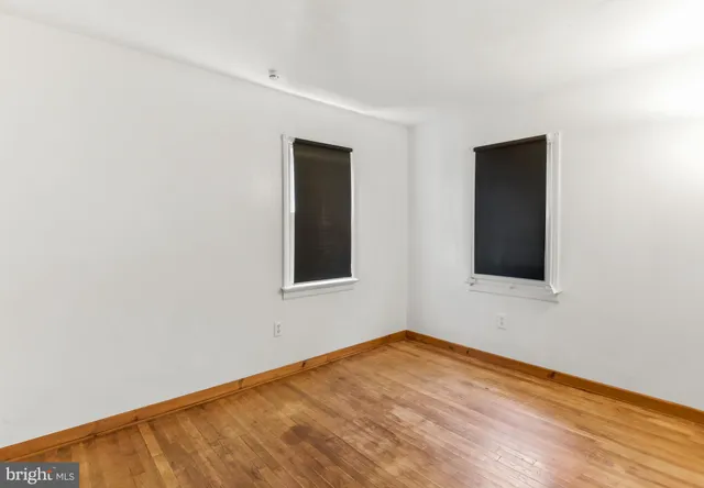a view of a room with wooden chairs