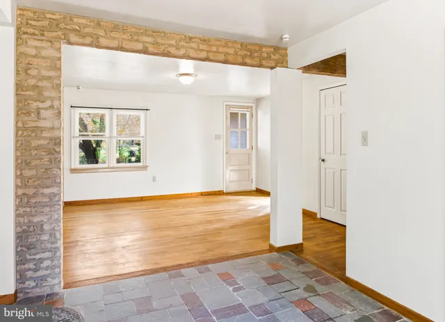 wooden floor in an empty room with a fireplace