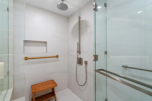 a bathroom with a tub sink shower and mirror