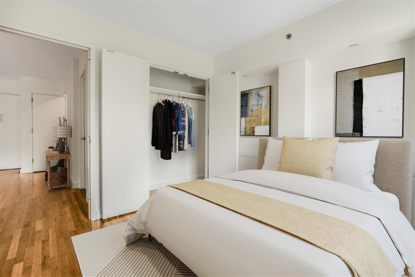 101 West 15th Street, Unit 229 Manhattan, NY 10011 - Photo 2 of 7 a bedroom with a bed and wooden floor