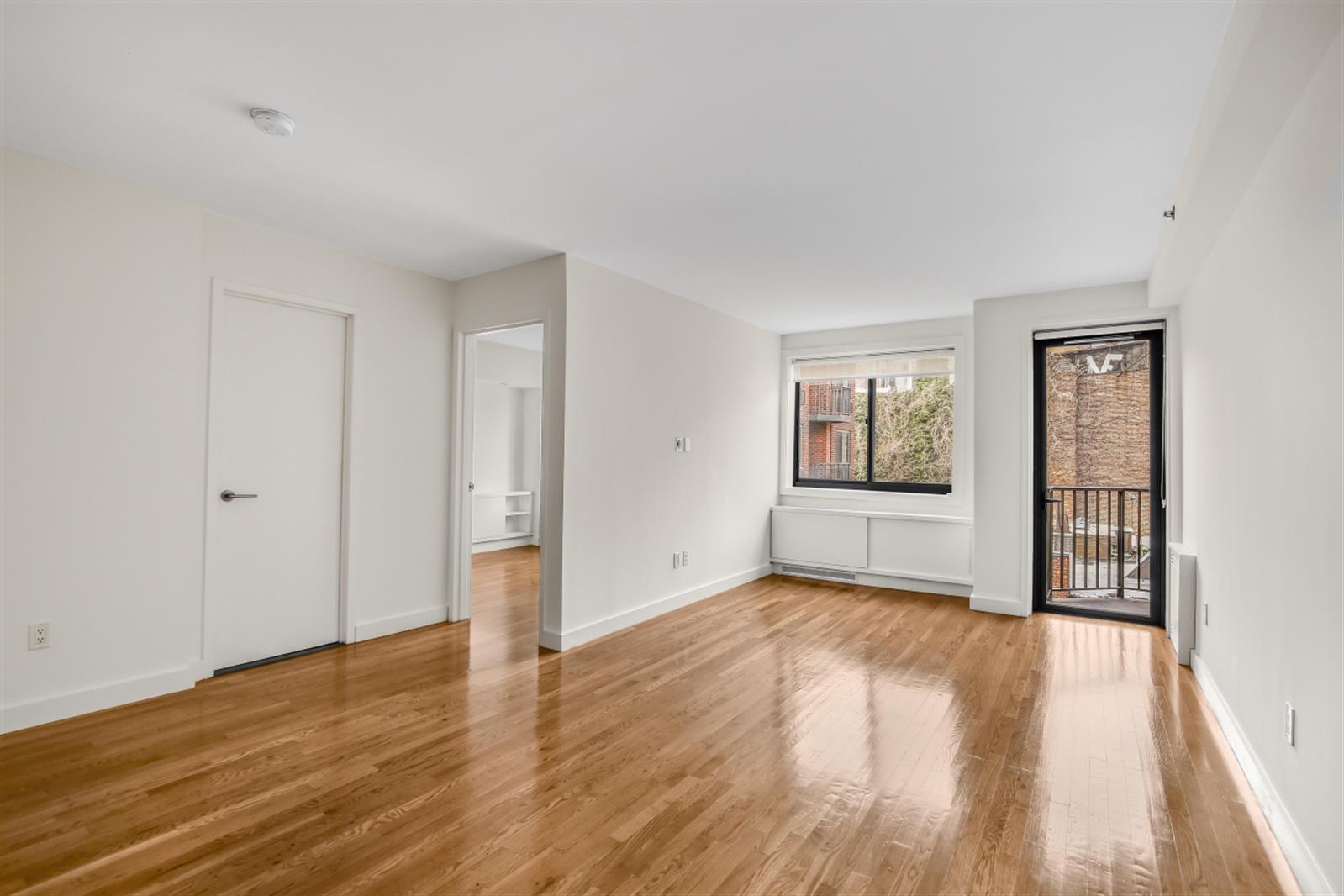 101 West 15th Street, Unit 229 Manhattan, NY 10011 - Photo 5 of 7 a view of an empty room with window and wooden floor