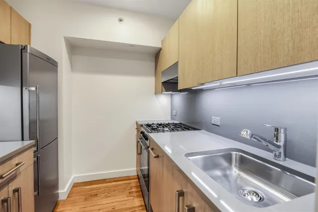 a kitchen with a sink and a refrigerator