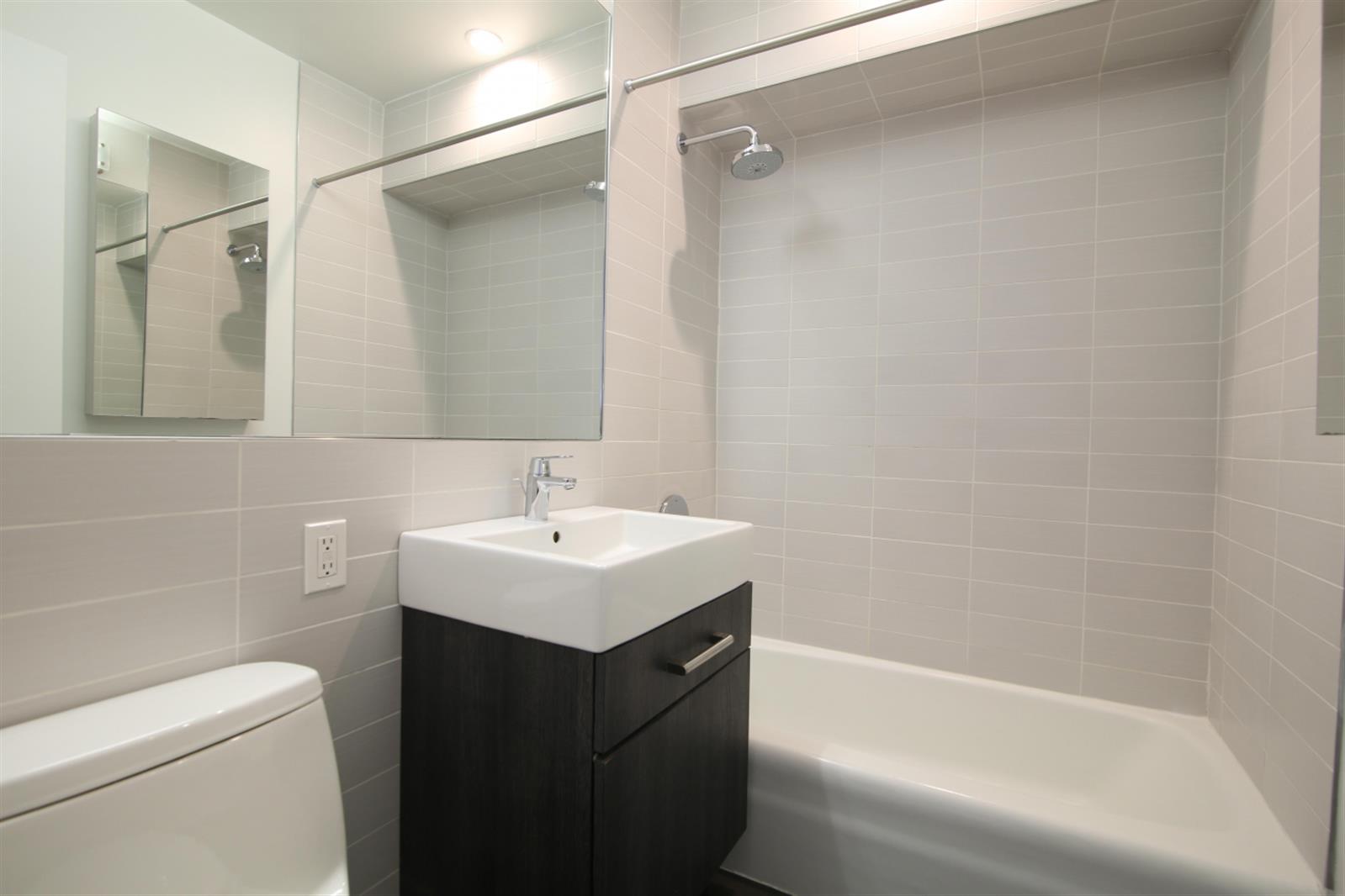 101 West 15th Street, Unit 229 Manhattan, NY 10011 - Photo 7 of 7 a bathroom with a sink a toilet and shower