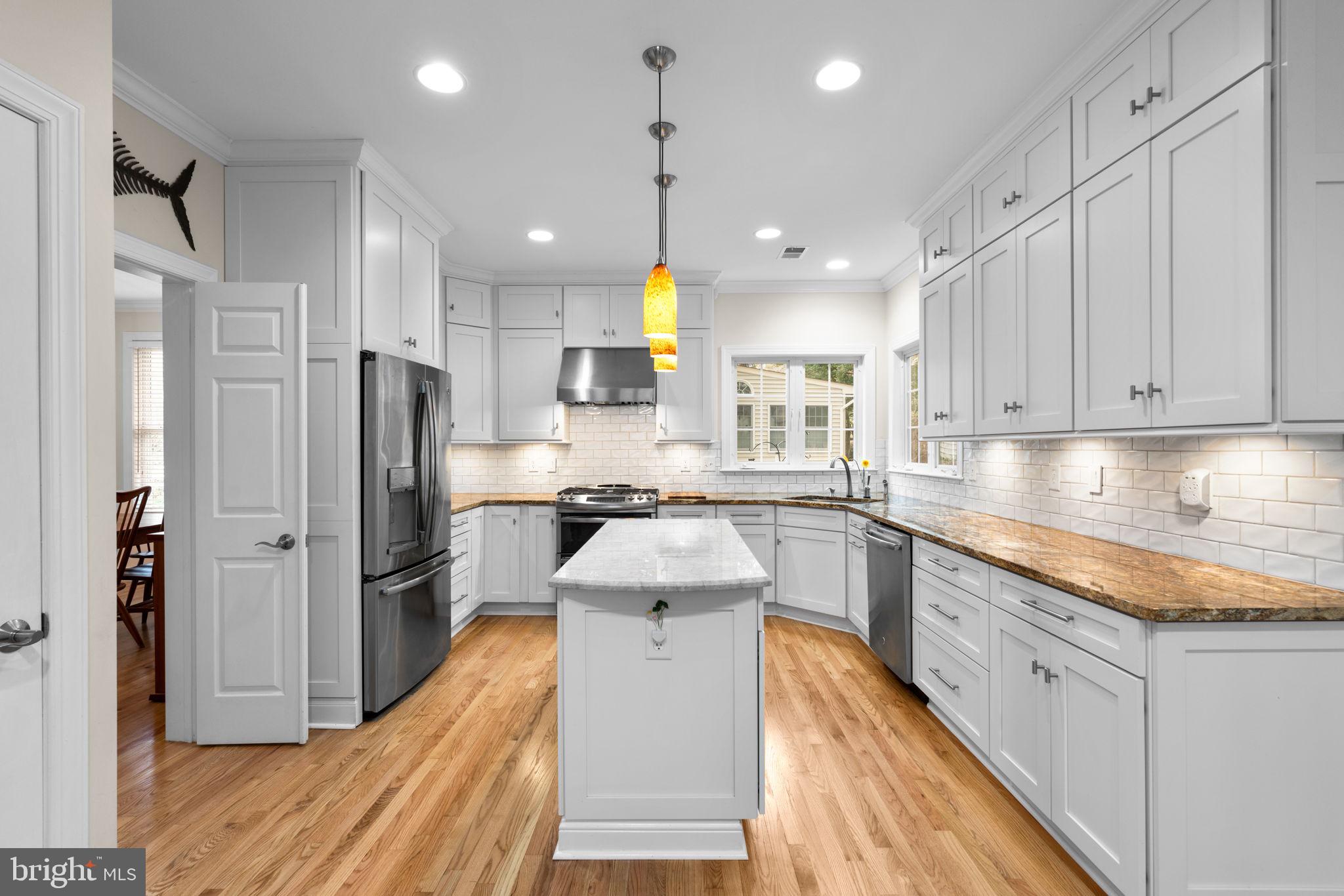 6429 Empty Song Road Columbia, MD 21044 - Photo 12 of 54 a kitchen with stainless steel appliances granite countertop a sink refrigerator and cabinets