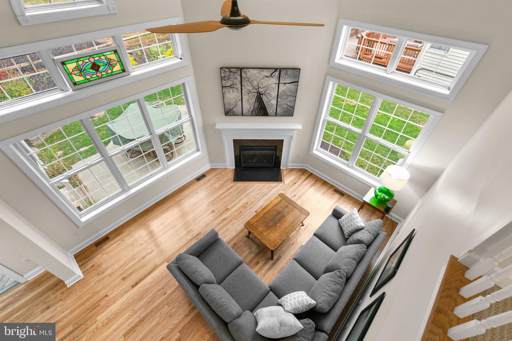 6429 Empty Song Road Columbia, MD 21044 - Photo 21 of 54 a living room with furniture a fireplace and a large window