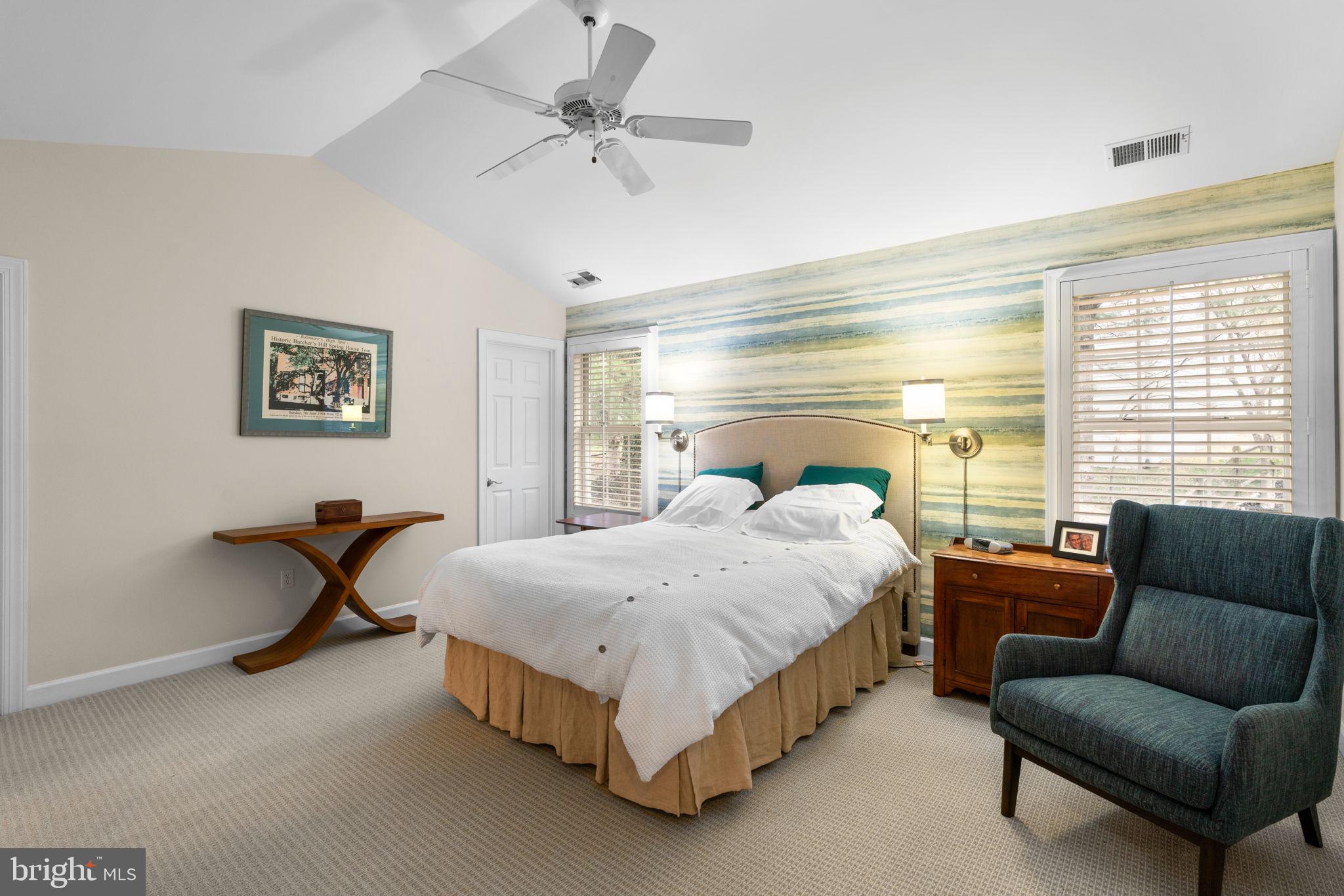 6429 Empty Song Road Columbia, MD 21044 - Photo 22 of 54 a bedroom with a bed a couch and a chandelier