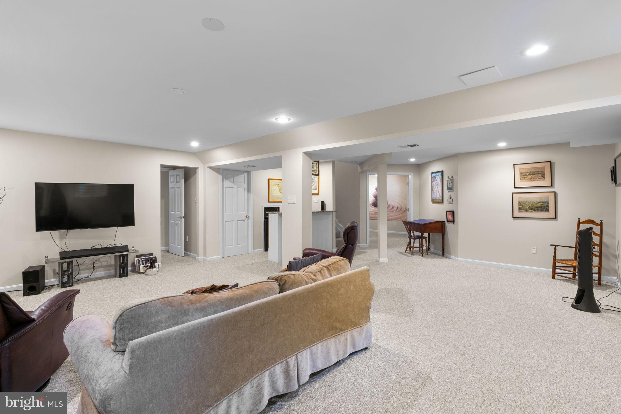 6429 Empty Song Road Columbia, MD 21044 - Photo 32 of 54 a living room with furniture and a flat screen tv