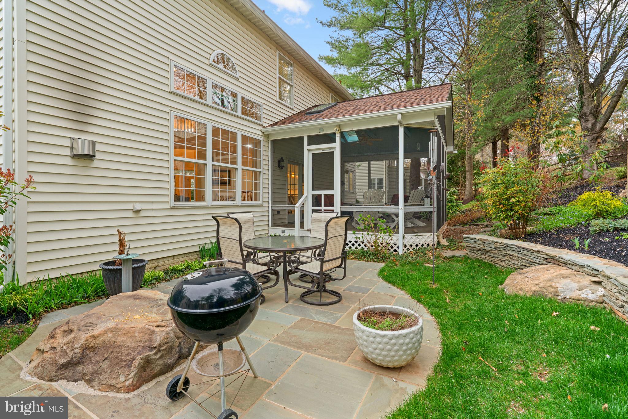 6429 Empty Song Road Columbia, MD 21044 - Photo 41 of 54 a view of a backyard with table and chairs and potted plants