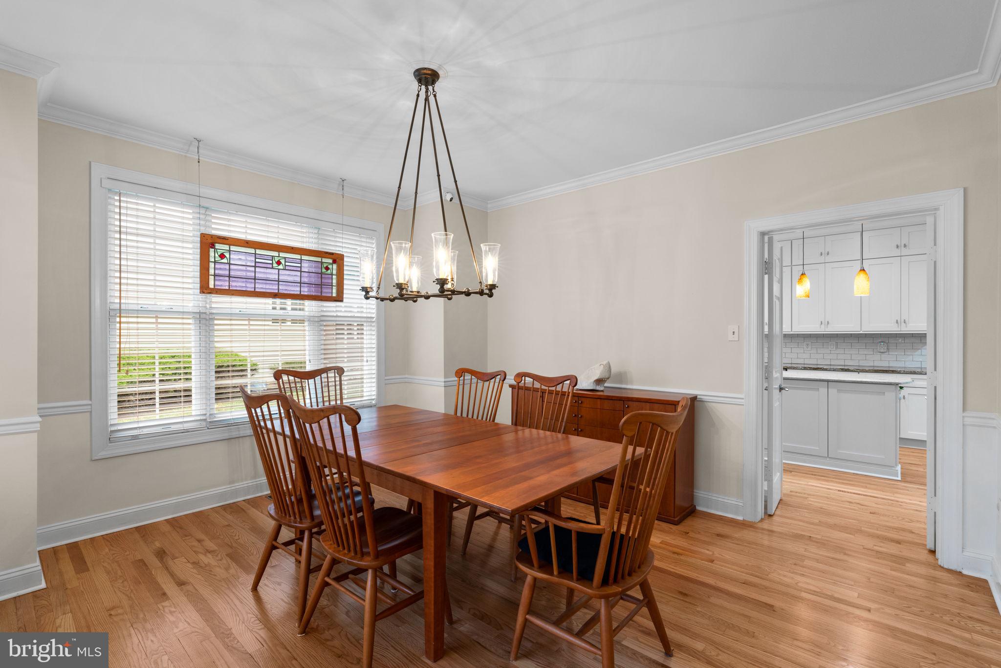 6429 Empty Song Road Columbia, MD 21044 - Photo 7 of 54 a view of a dining room with furniture window and wooden floor