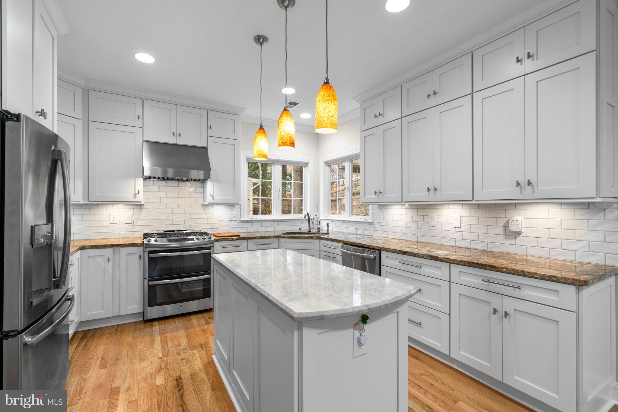 6429 Empty Song Road Columbia, MD 21044 - Photo 10 of 54 a kitchen with stainless steel appliances granite countertop a sink a stove and a refrigerator
