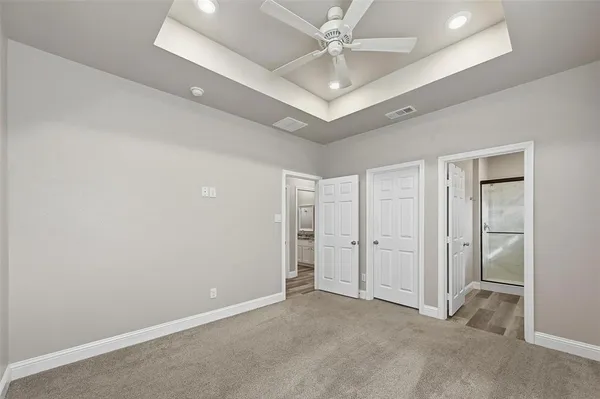 en empty room with fan and a ceiling fan