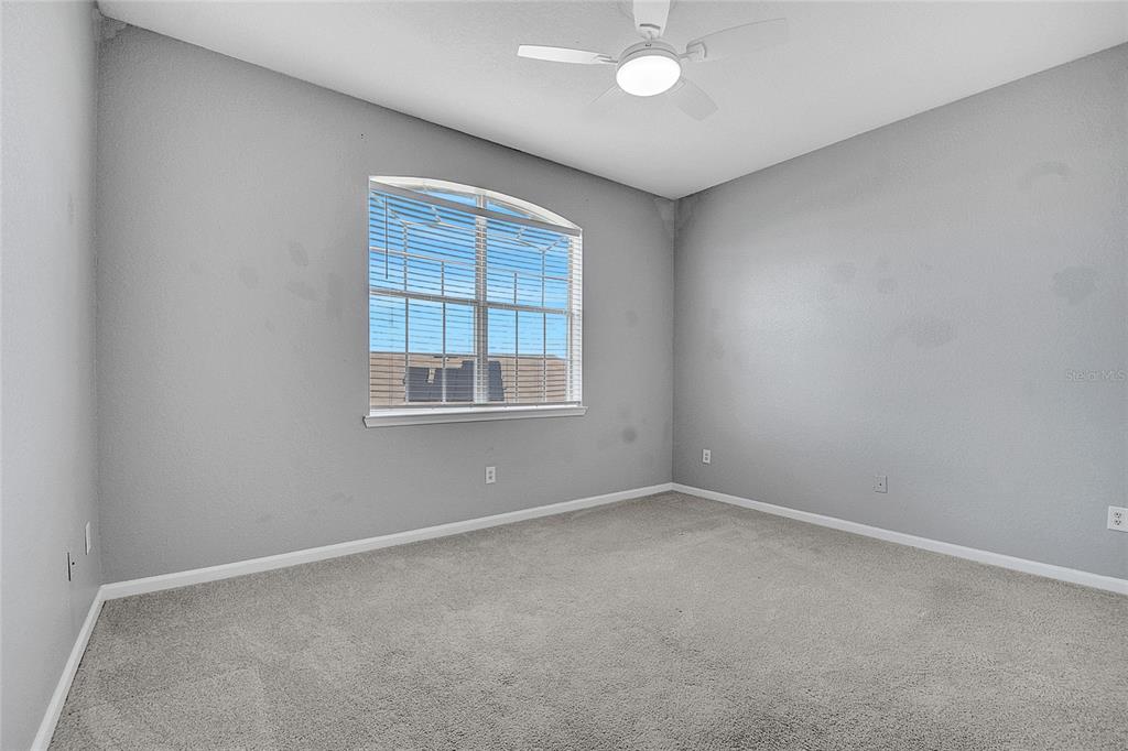 617 Terrace Ridge Circle, Unit 617 Davenport, FL 33896 - Photo 11 of 40 an empty room with a empty space and windows