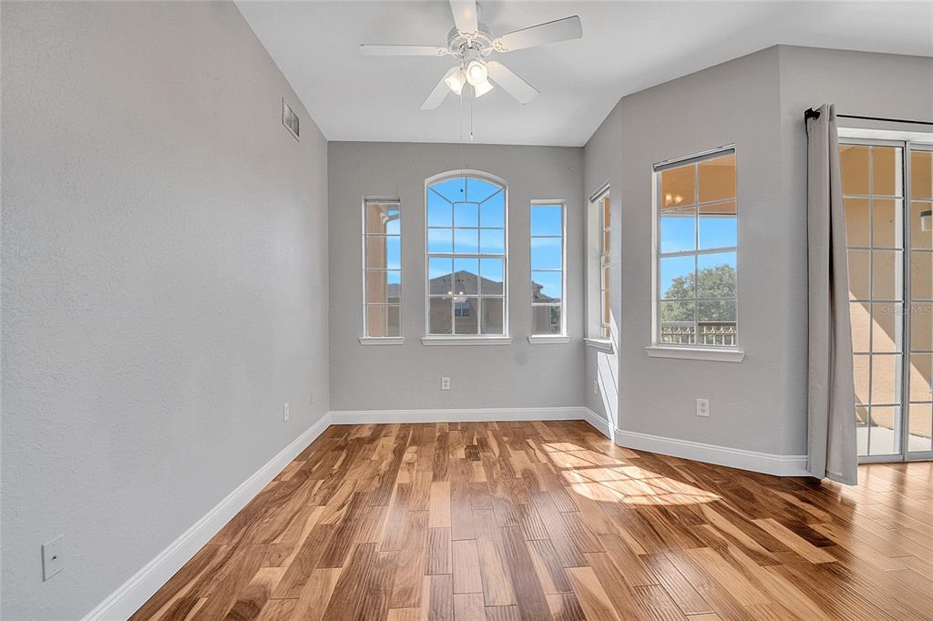 617 Terrace Ridge Circle, Unit 617 Davenport, FL 33896 - Photo 18 of 40 a view of empty room with wooden floor and fan