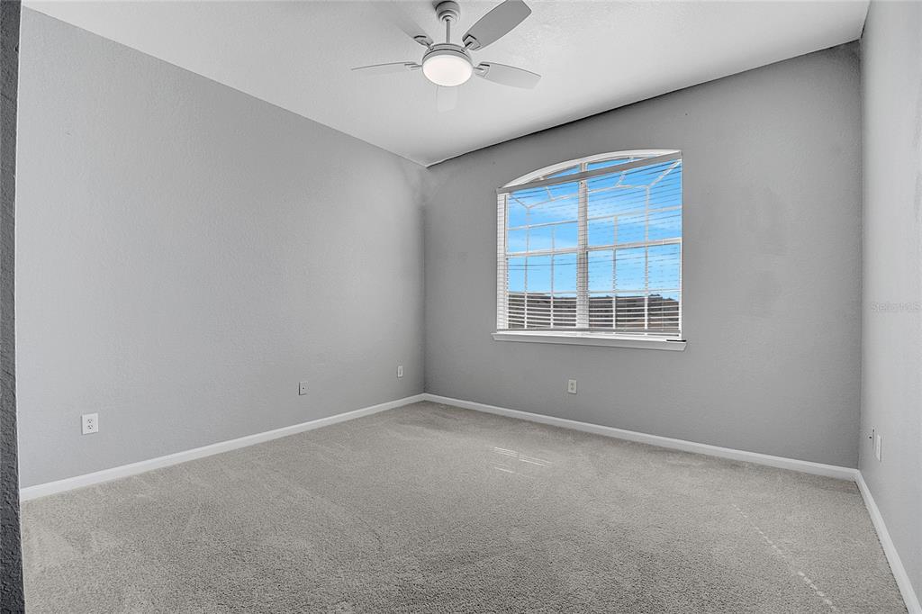 617 Terrace Ridge Circle, Unit 617 Davenport, FL 33896 - Photo 22 of 40 an empty room with a window and a fan
