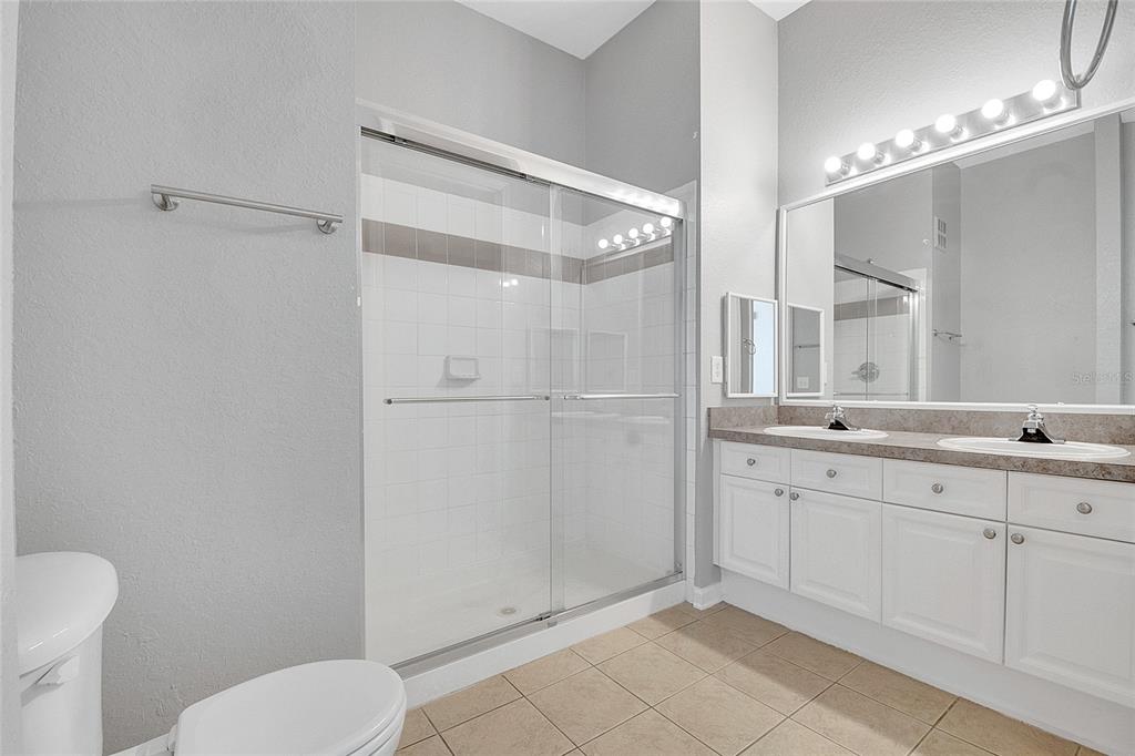 617 Terrace Ridge Circle, Unit 617 Davenport, FL 33896 - Photo 26 of 40 a bathroom with a toilet sink and shower