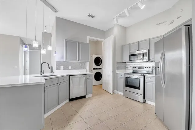a kitchen with cabinets and stainless steel appliances